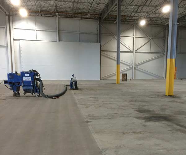 Concrete floor captive shot blasting