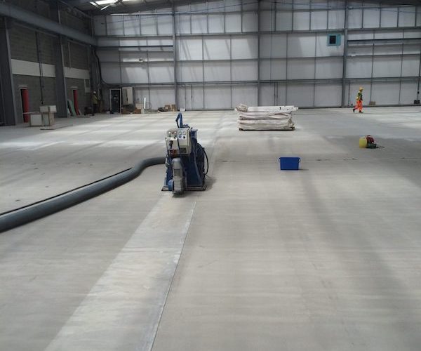 Captive Shot Blasting a large unit in preparation for a specialist floor coating